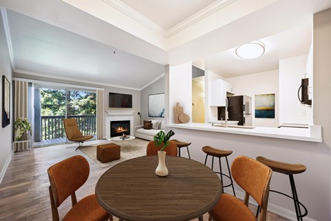 A modern dining room with a wooden table and chairs.