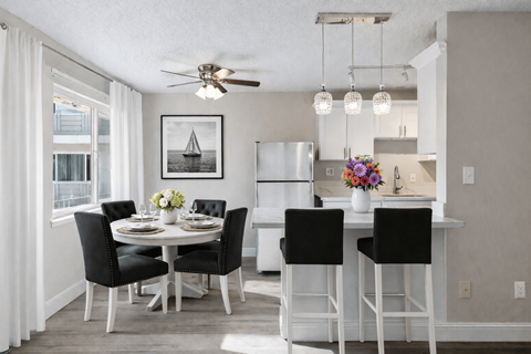A dining room with a table set for four.
