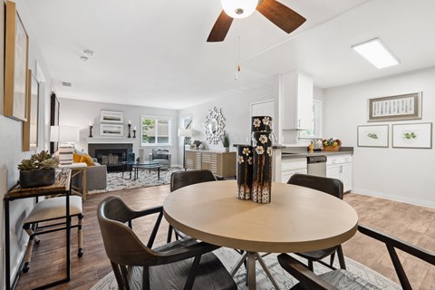 A modern dining room with a round table and chairs.