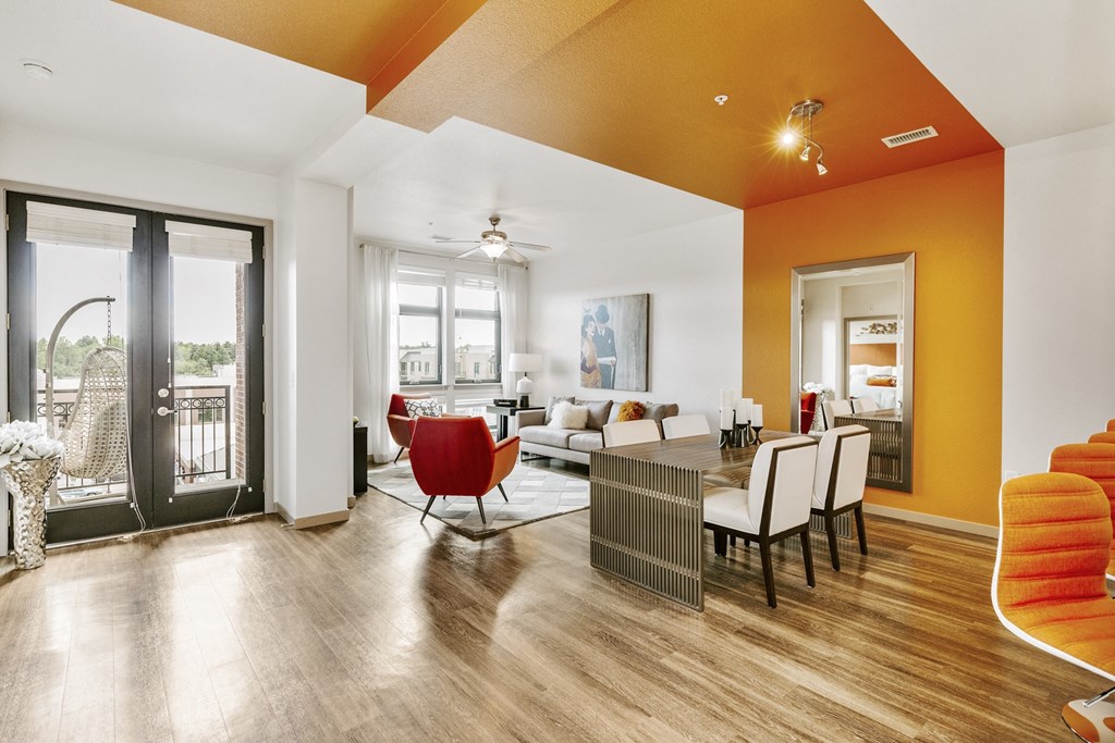 a living room and dining room with a table and chairs