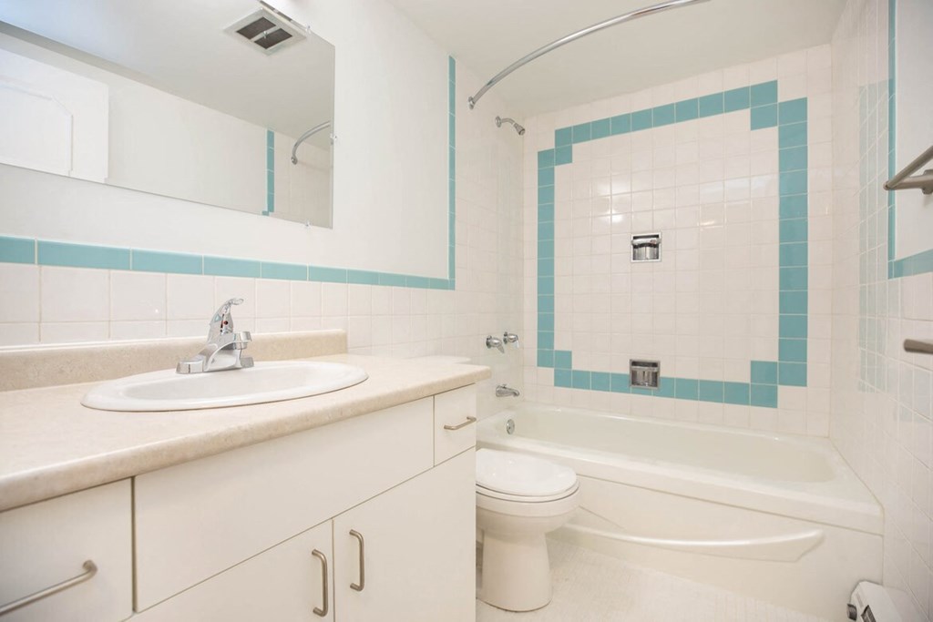 a bathroom with a sink toilet and a bath tub