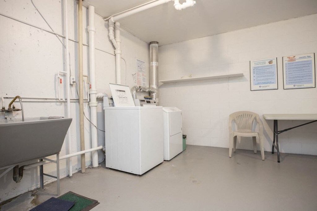 a room with two refrigerators and a table and a chair