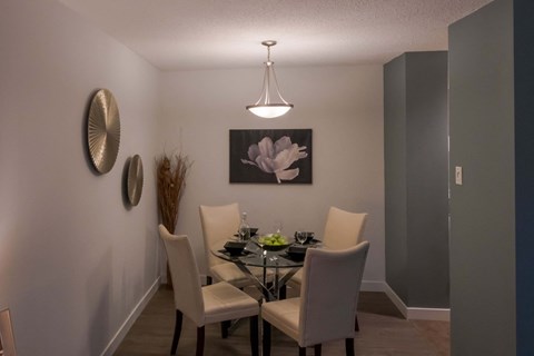 A dining room with a table set for two.