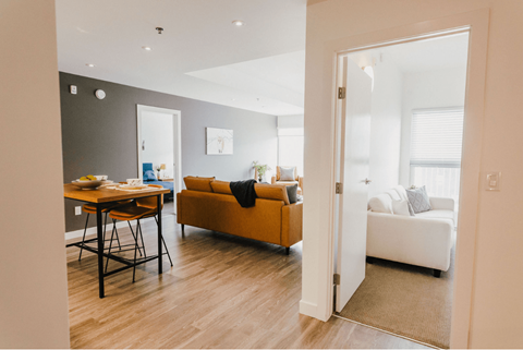a living room and dining room with a couch and a table