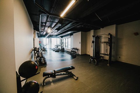 a gym with weights and other equipment in a building