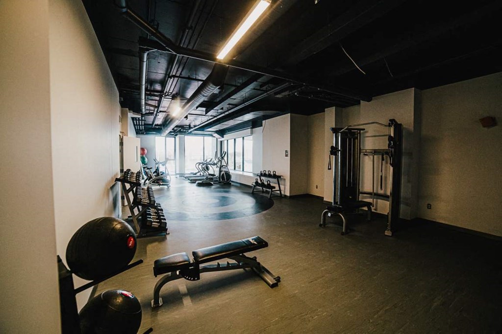 a gym with weights and other equipment in a building