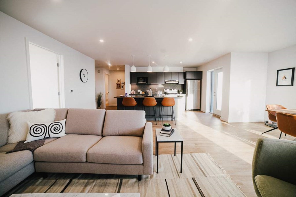 a living room with a couch and a kitchen in the background