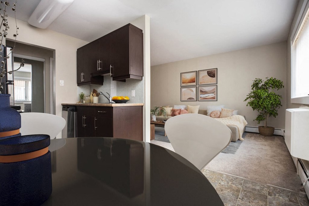 a kitchen and living room with a table and chairs