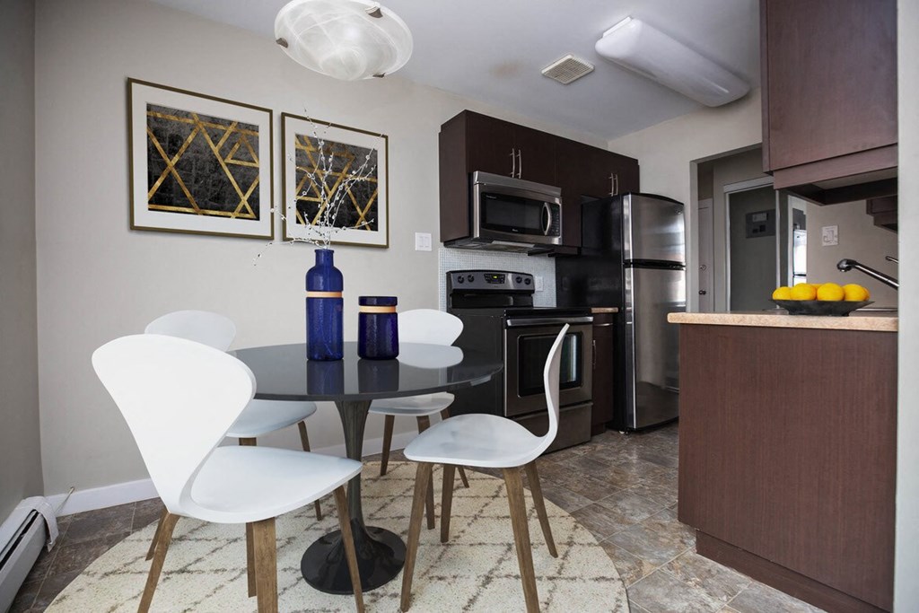 a kitchen and dining room with a table and chairs