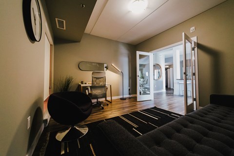 a living room with a couch and a chair and a staircase