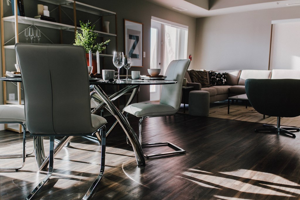 a living room with a dining room table and chairs