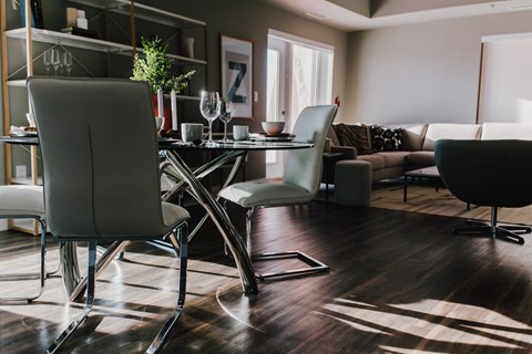 a living room with a dining room table and chairs