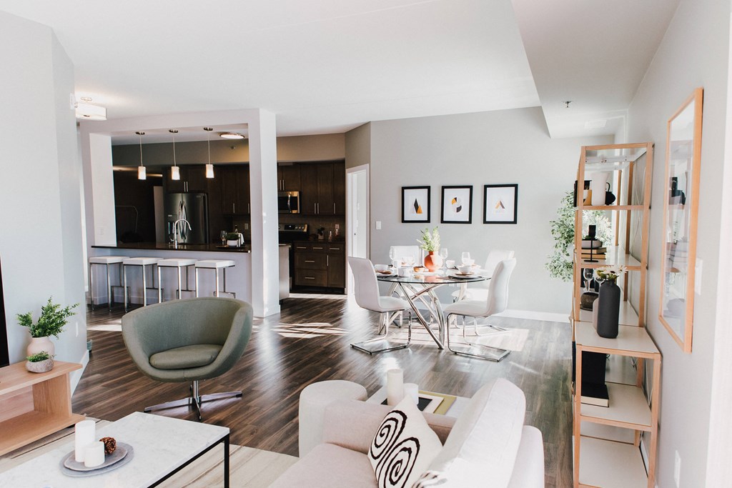 a living room and dining room with a table and chairs