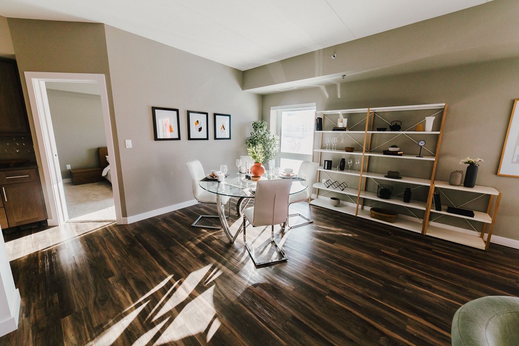 a dining room with a table and chairs and a book shelf