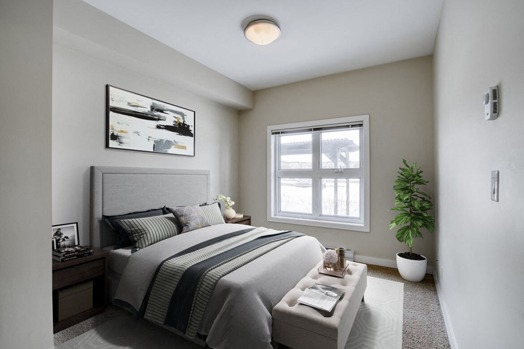 a bedroom with a bed and a window