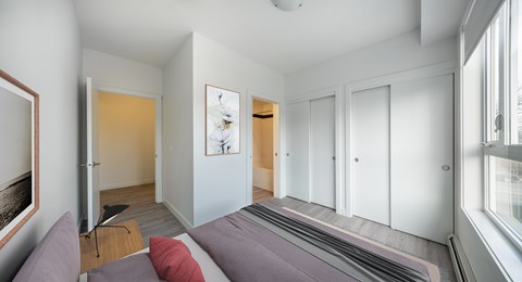 A bedroom with a bed and a painting on the wall.