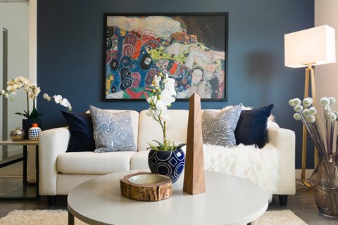 a living room with blue walls and a white couch and a coffee table