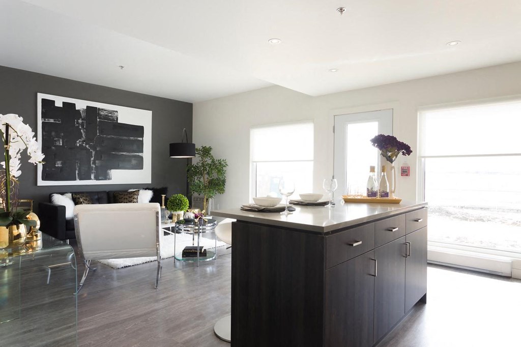 a kitchen and living room with a black accent wall