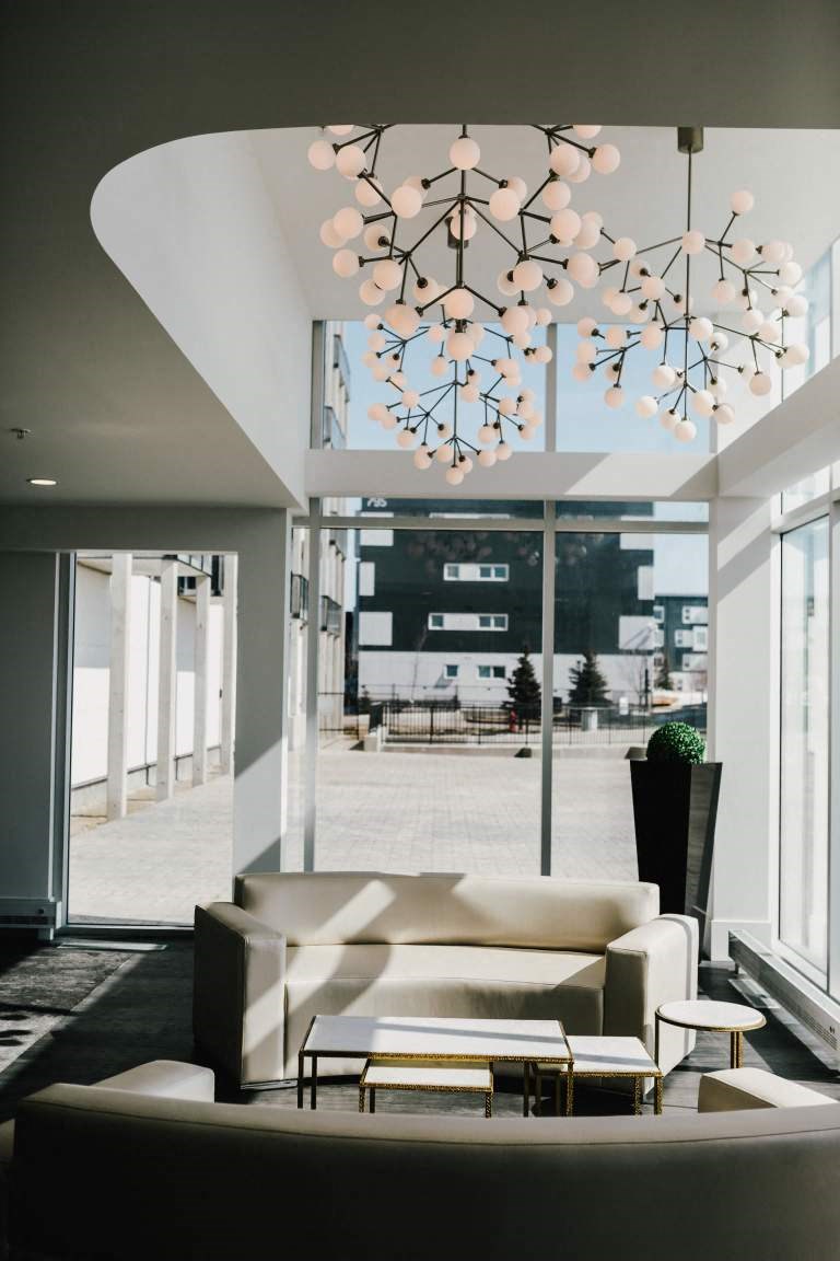 a living room with a couch and a chandelier