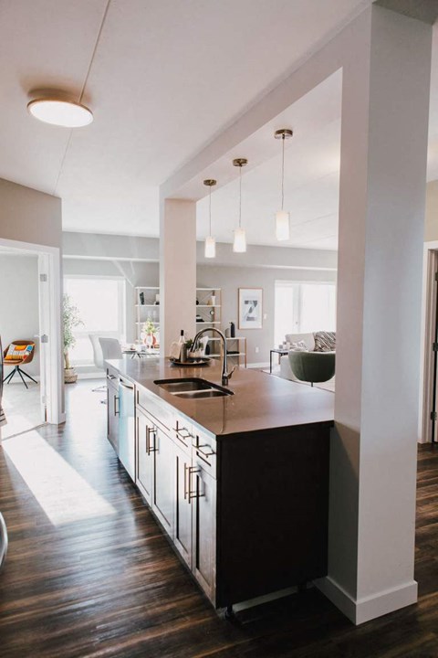a large kitchen with a sink and a counter top