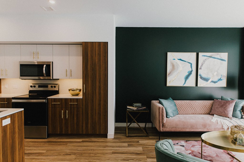 a living room with a couch and a kitchen