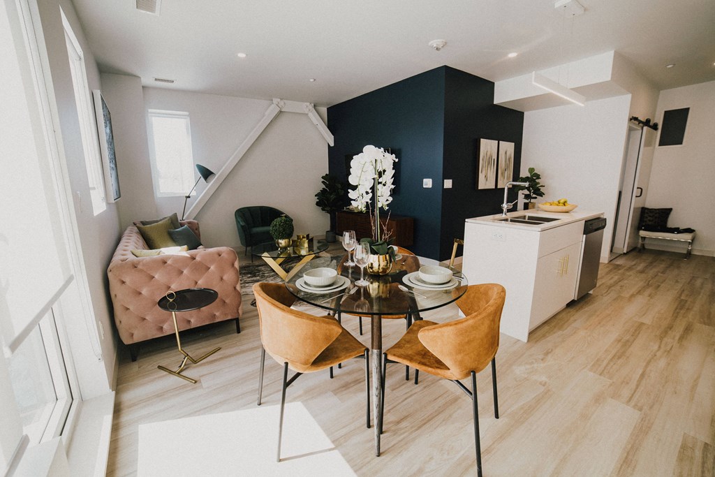 a living room and dining room with a table and chairs
