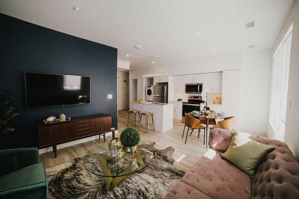 A modern living room with a dark blue wall and a flat screen TV.