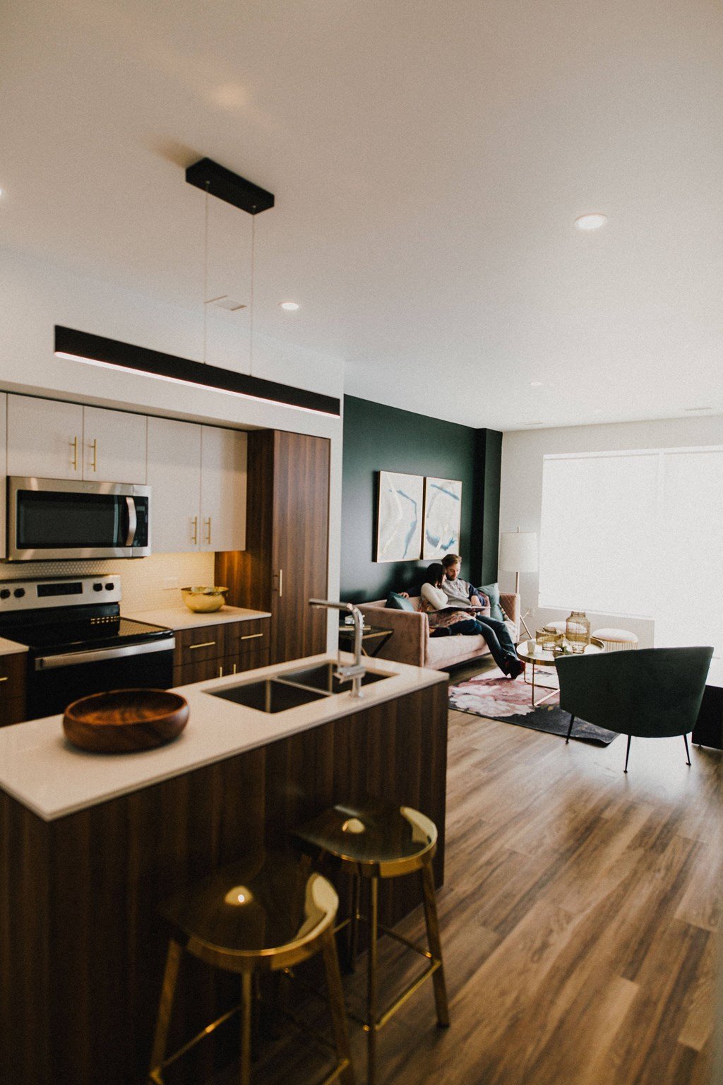 A modern kitchen with a bar stool and a chair.