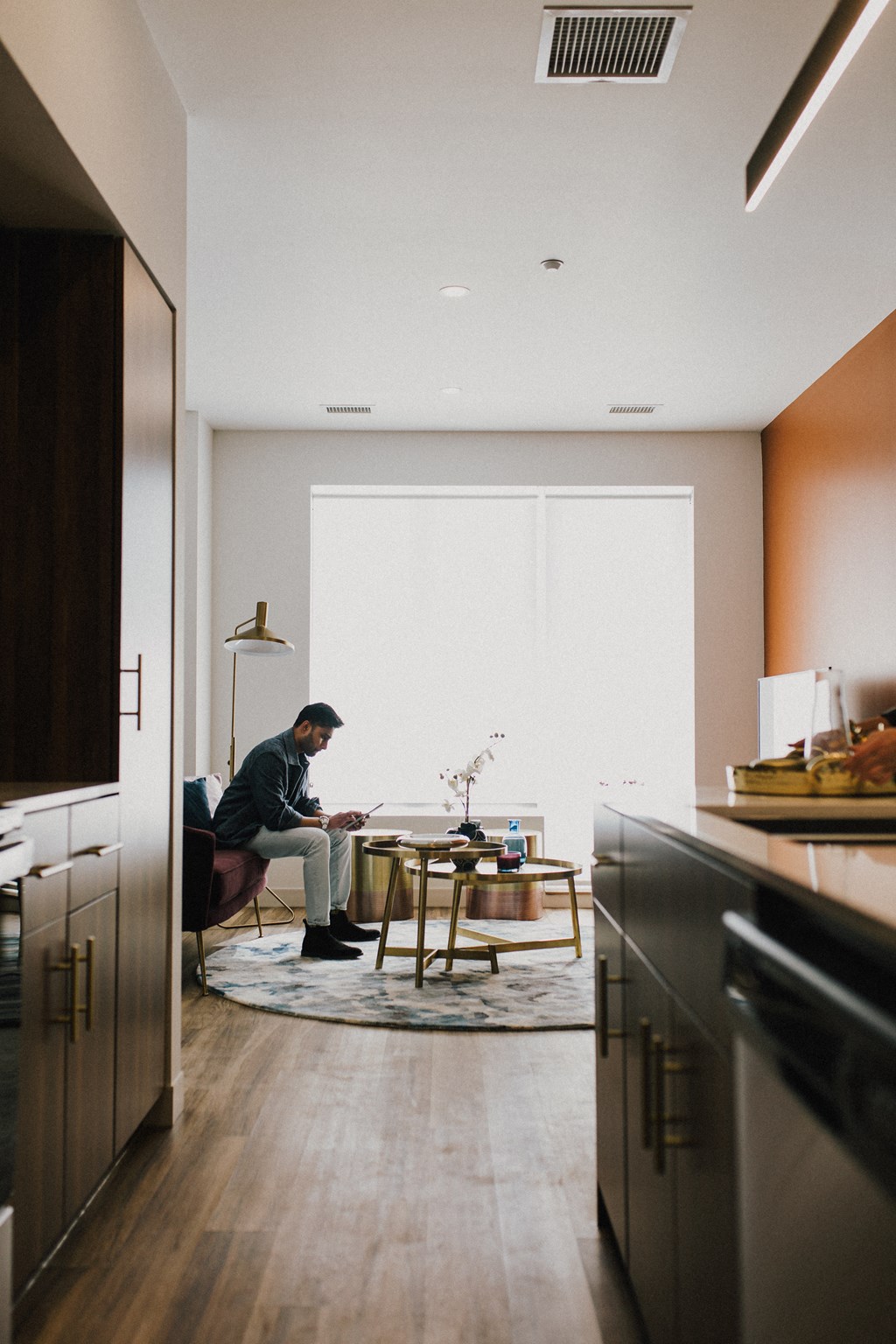 a man sitting in a chair at a table in a living room