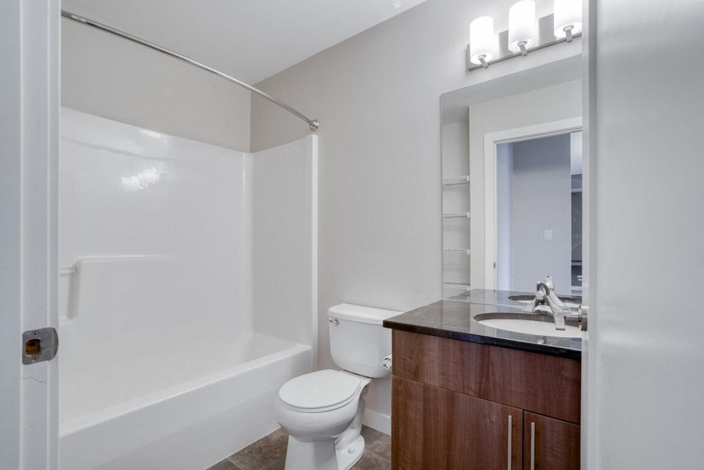 a bathroom with a toilet sink and a shower