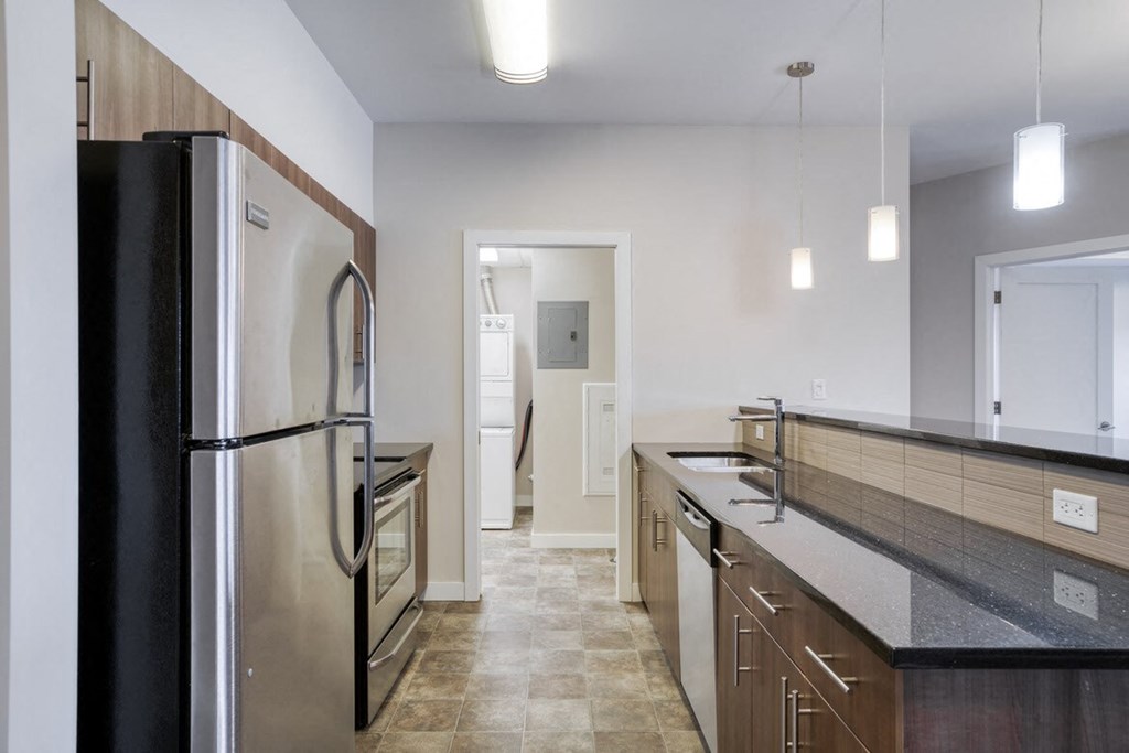 a kitchen with a stainless steel refrigerator and counter tops