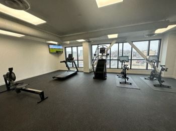 a large fitness room with treadmills and other exercise equipment