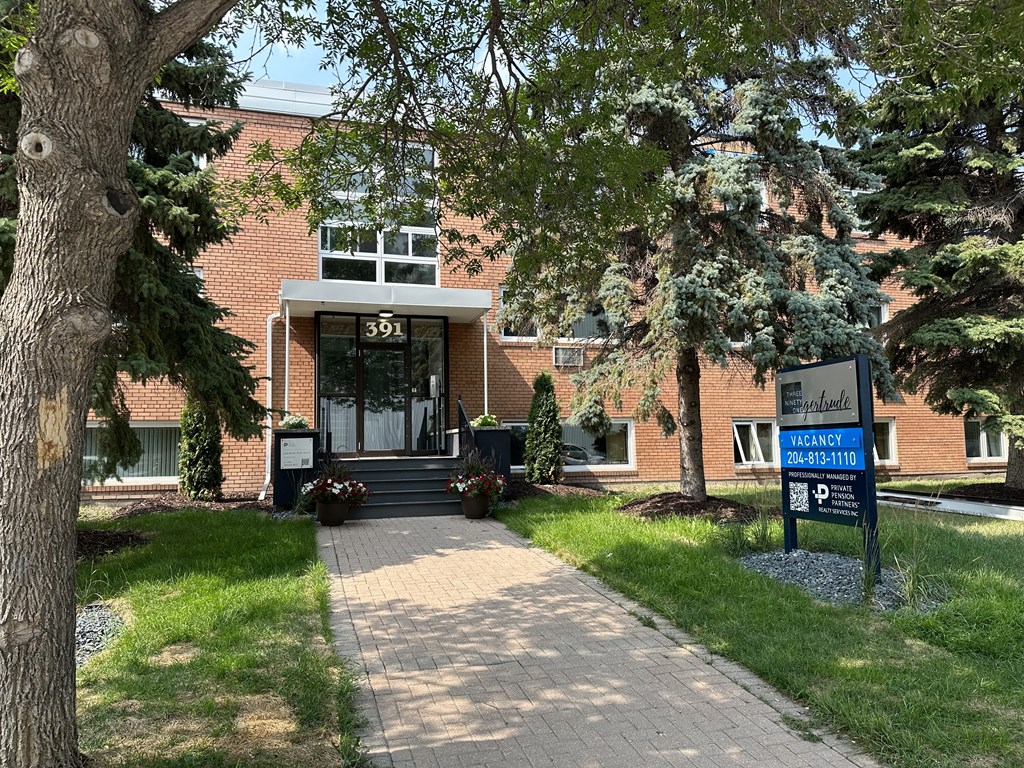 a brick building with trees