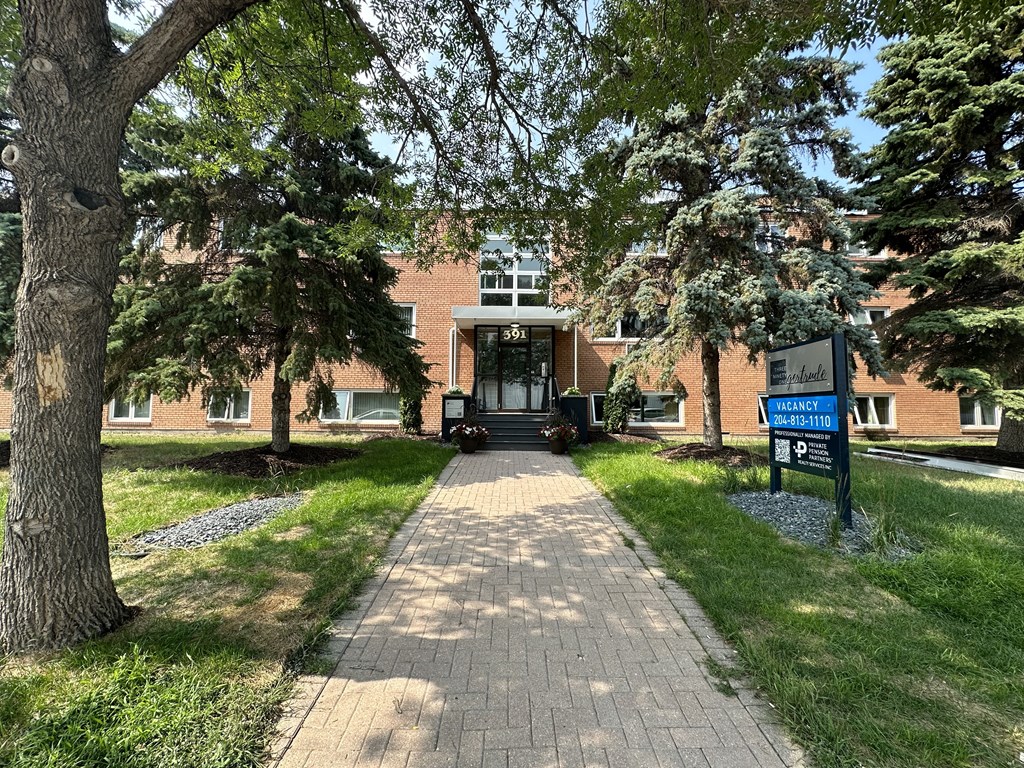 a brick building with trees in front of it