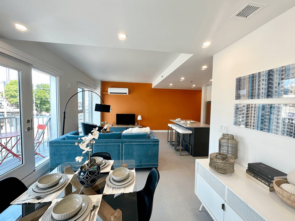 A modern dining room with a table set for a meal.