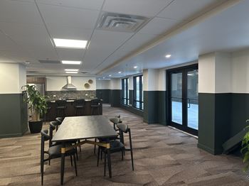 A conference room with a long table and chairs.