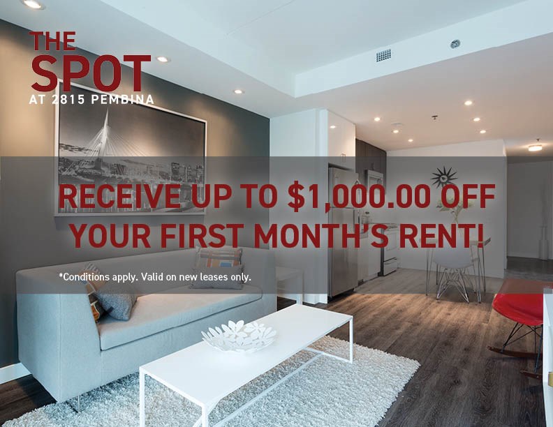 A living room with a white sofa and a sign offering up to $1,000 off the first month's rent.