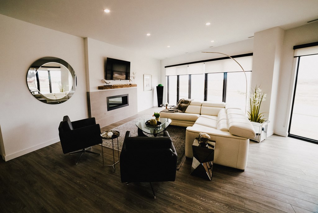 a living room with a couch and a chair and a fireplace