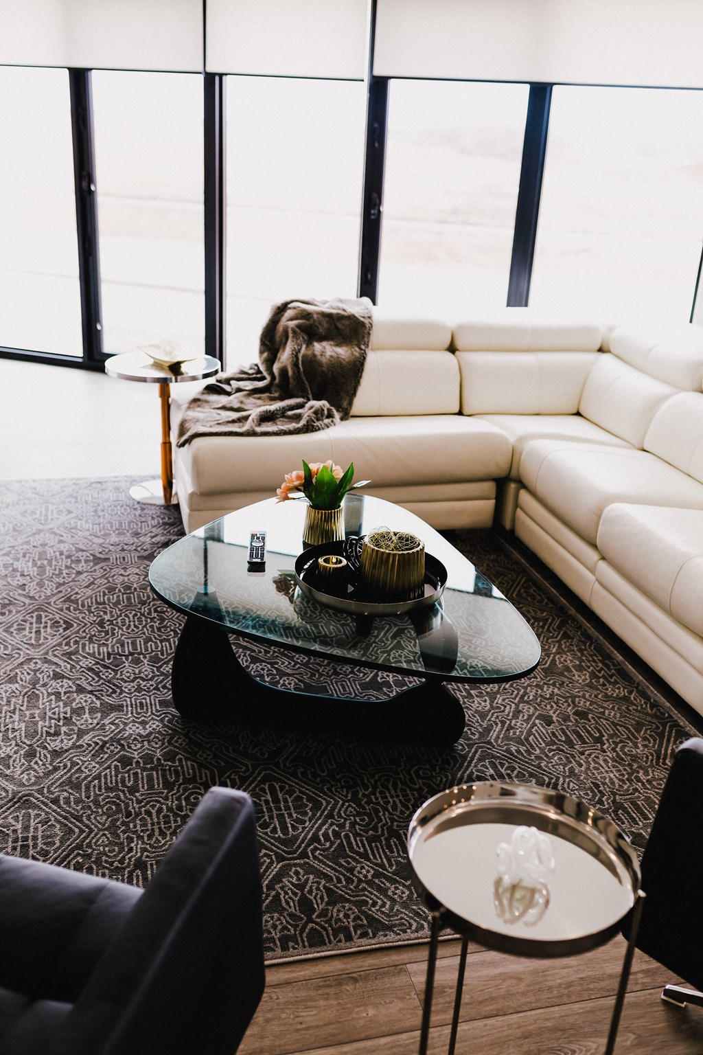 a living room with white couches and a coffee table