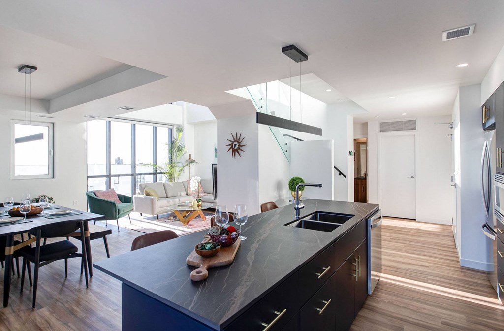 a kitchen with a large island and a living room