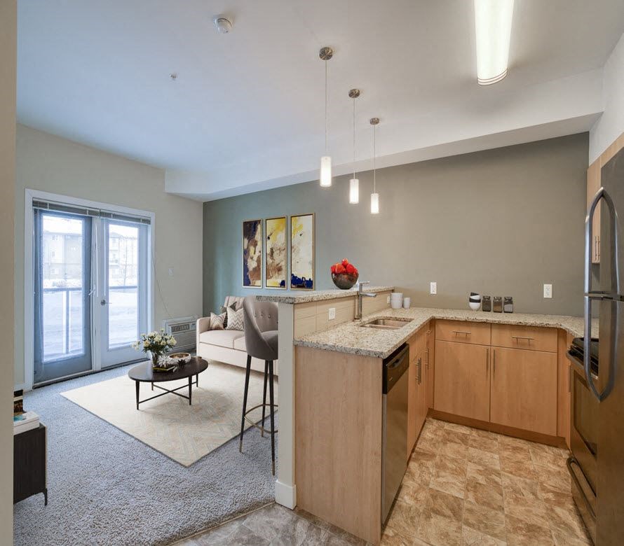 a kitchen and living room with an open floor plan