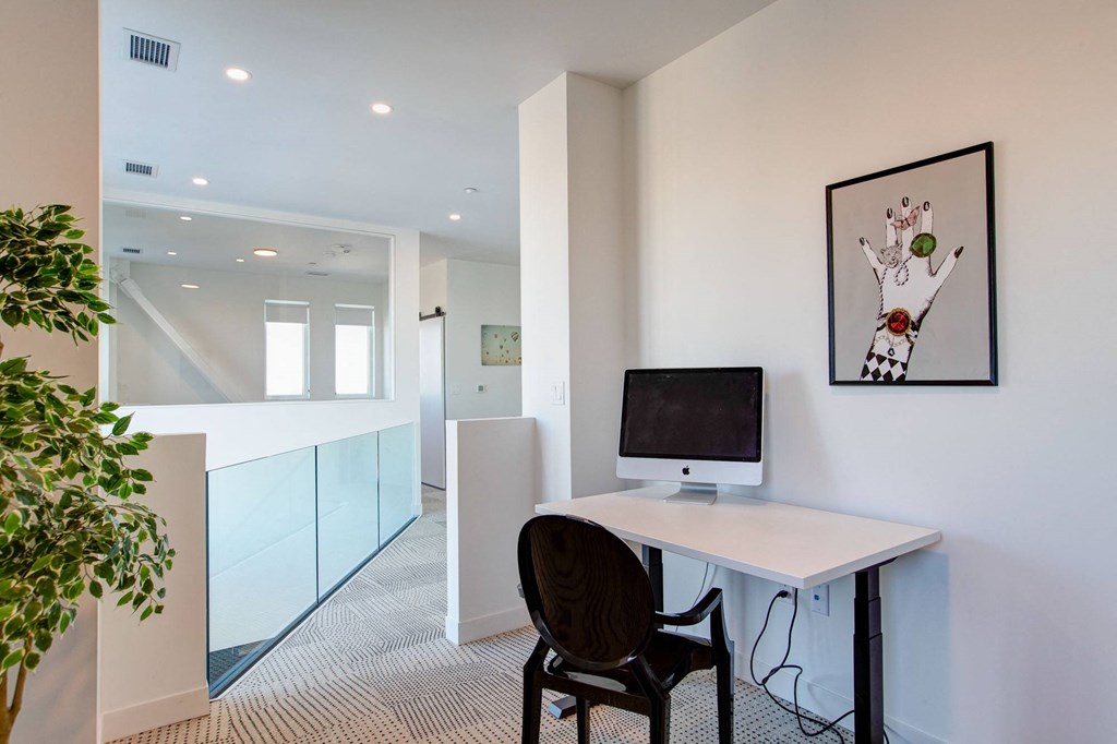 a home office with a computer on a desk