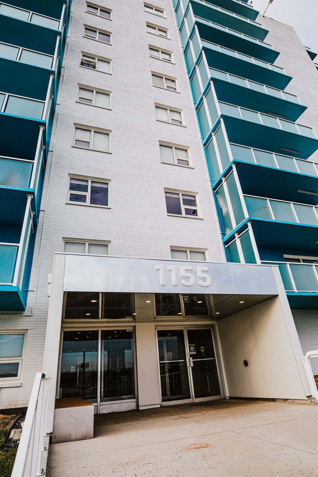 a tall building with a sign that reads 1155 on the front of it