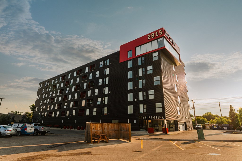 a large building with a red and black top