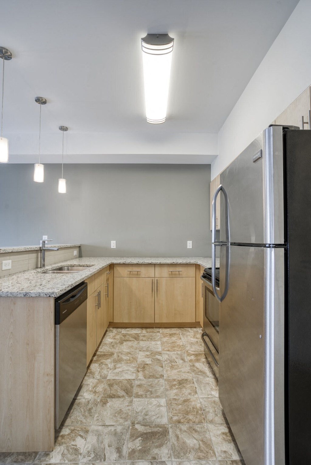 a kitchen with stainless steel appliances and marble counter tops