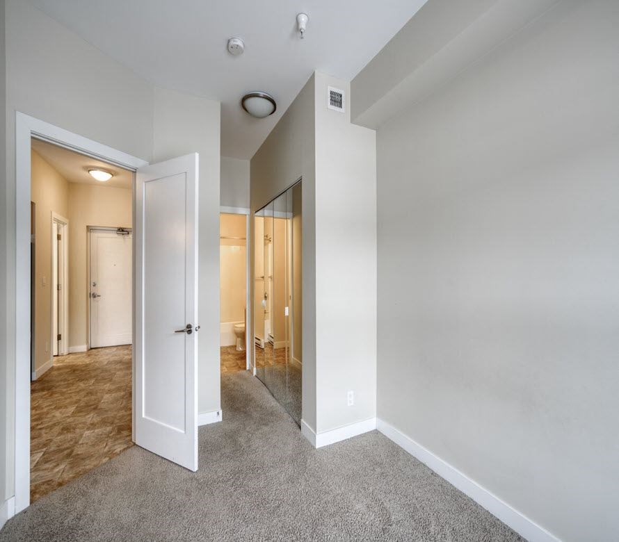 a bedroom with a closet and a mirror