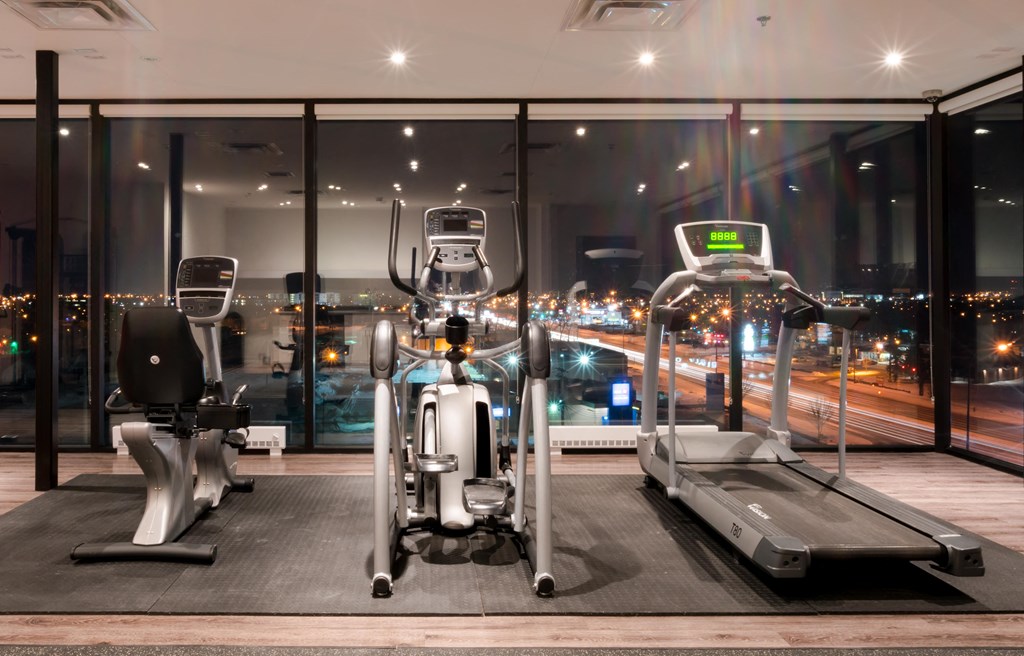 a gym with a view of the city at night