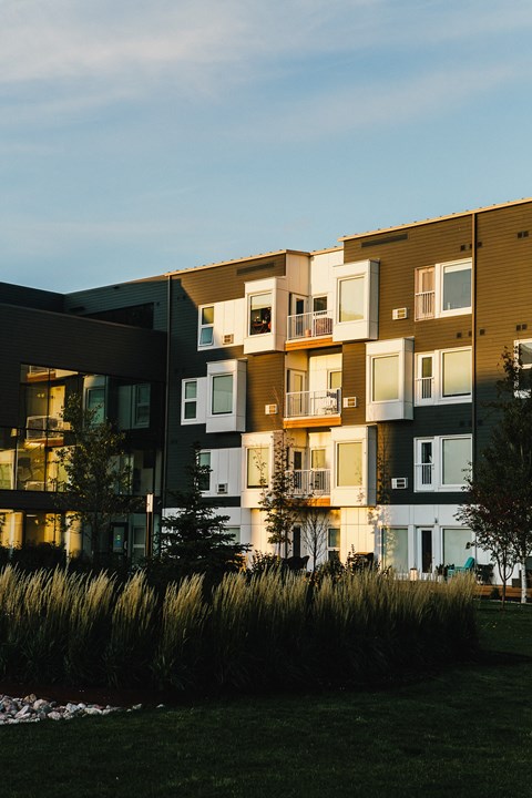 a row of modern apartment buildings at dusk