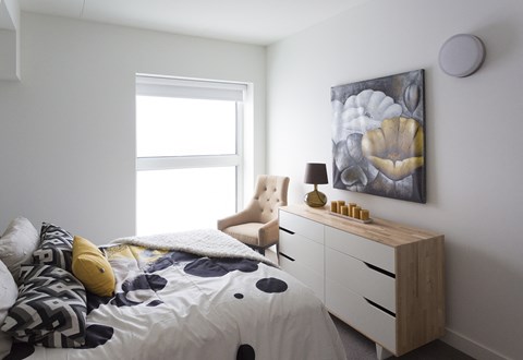 a bedroom with a bed and a dresser