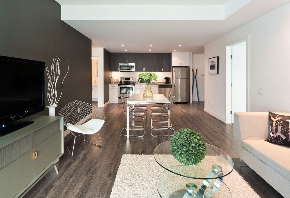 a view of a living room and kitchen in a two bedroom apartment